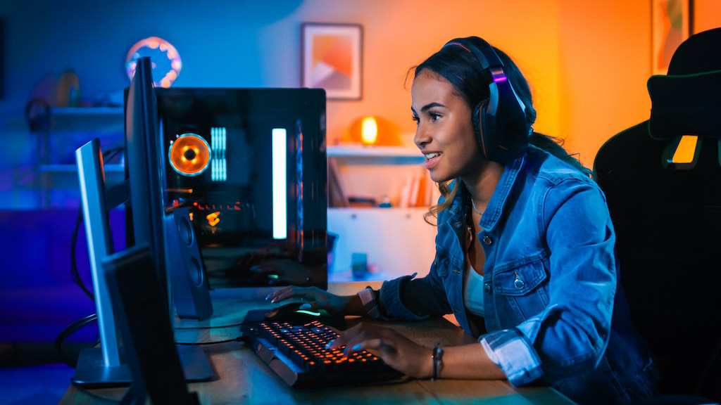 Woman looking at gaming computer.