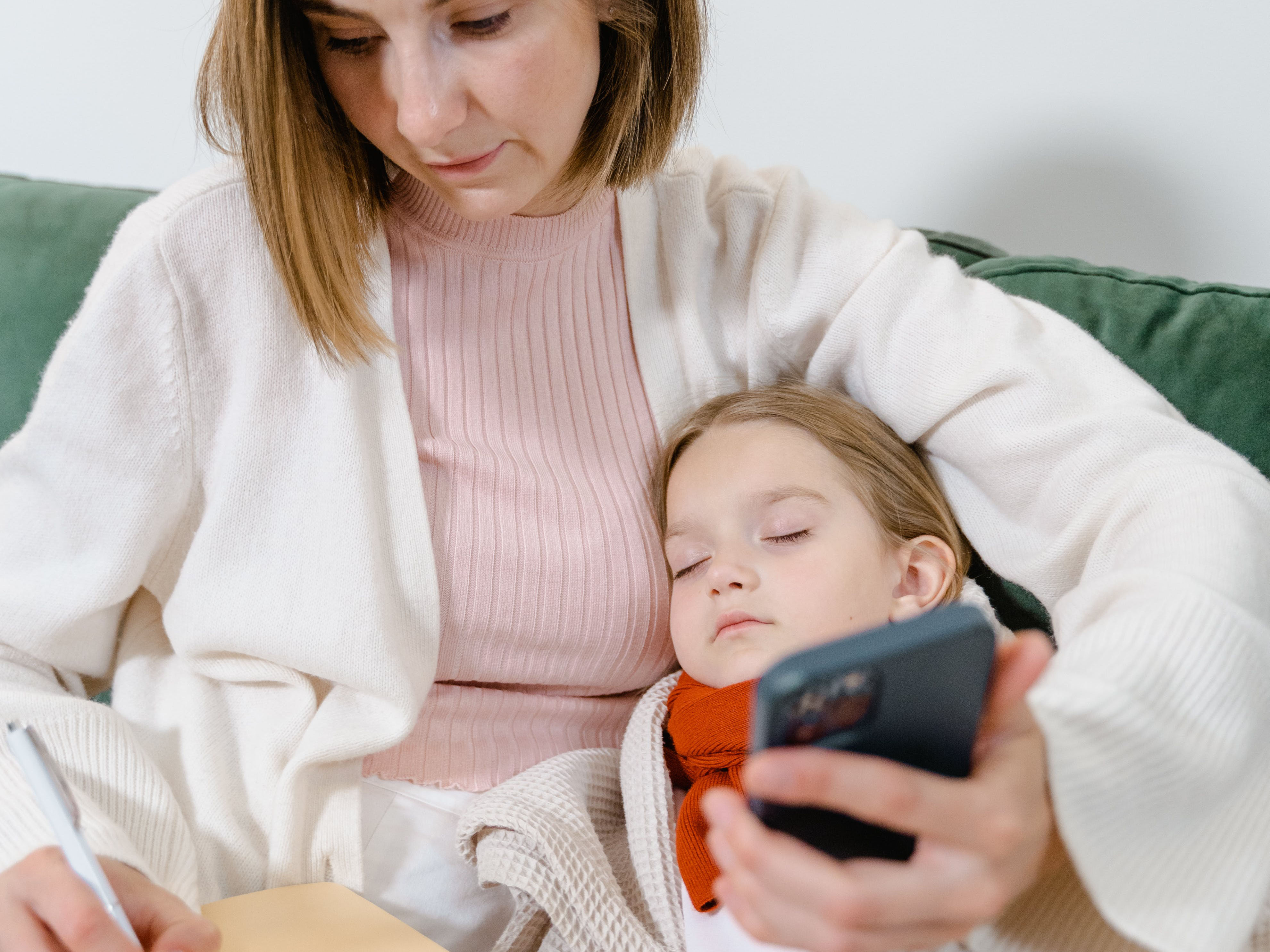 Mother with sick child using Telehealth to contact her doctor