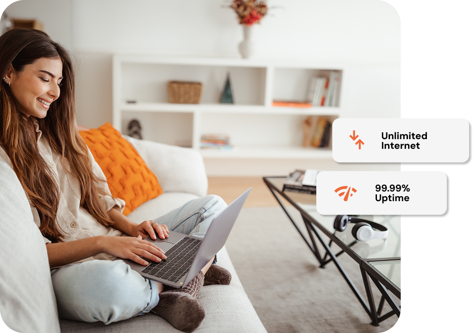 Cheerful adult woman typing on laptop.